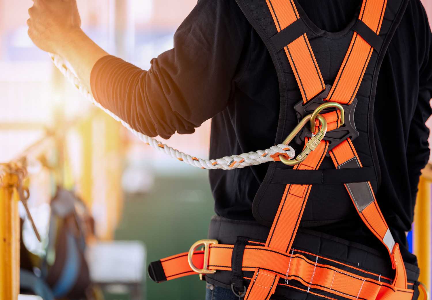 Construction worker wearing safety harness.